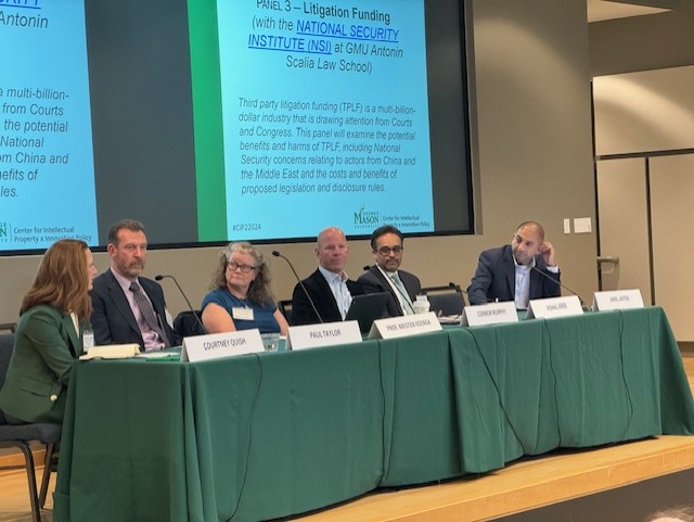 Photo of one of the Fall Conference panels in the Mason Square Auditorium